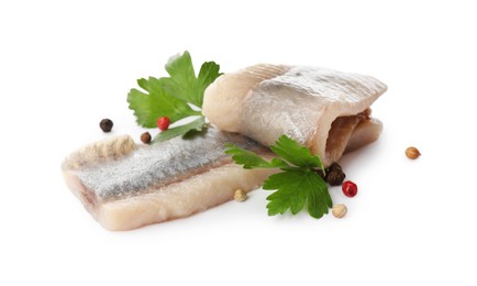 Photo of Delicious salted herring fillets with parsley and peppercorns on white background