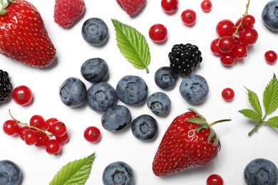 Mix of fresh berries on white background, flat lay