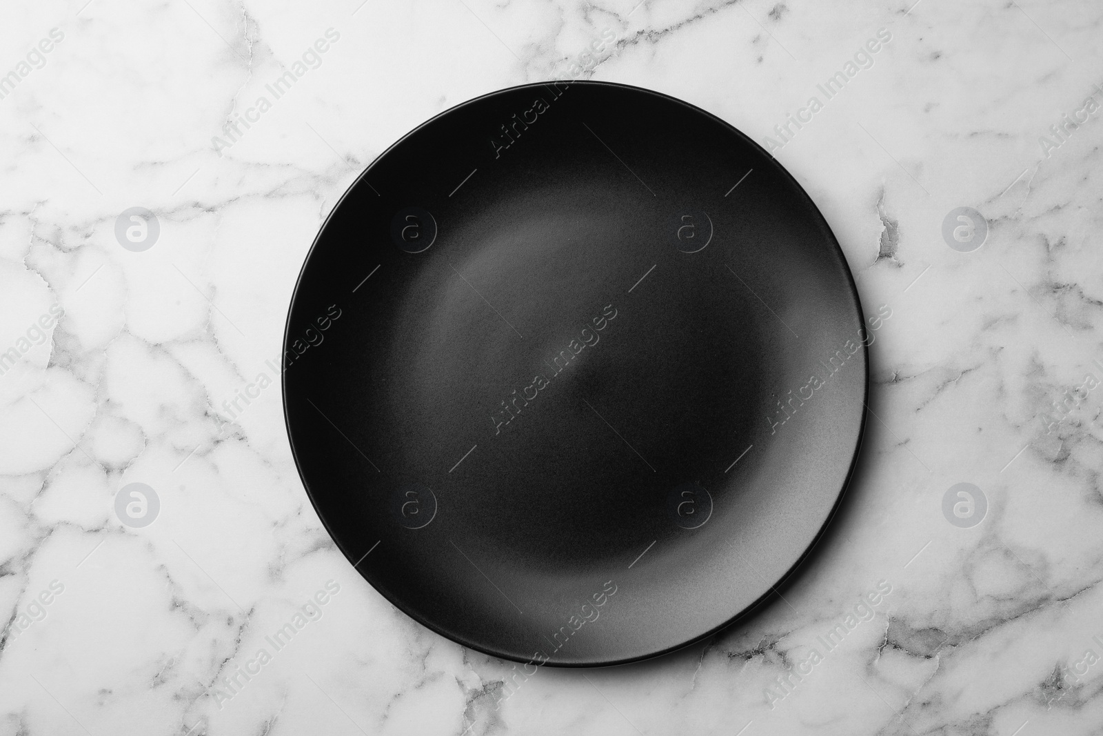 Photo of Stylish ceramic plate on marble background, top view