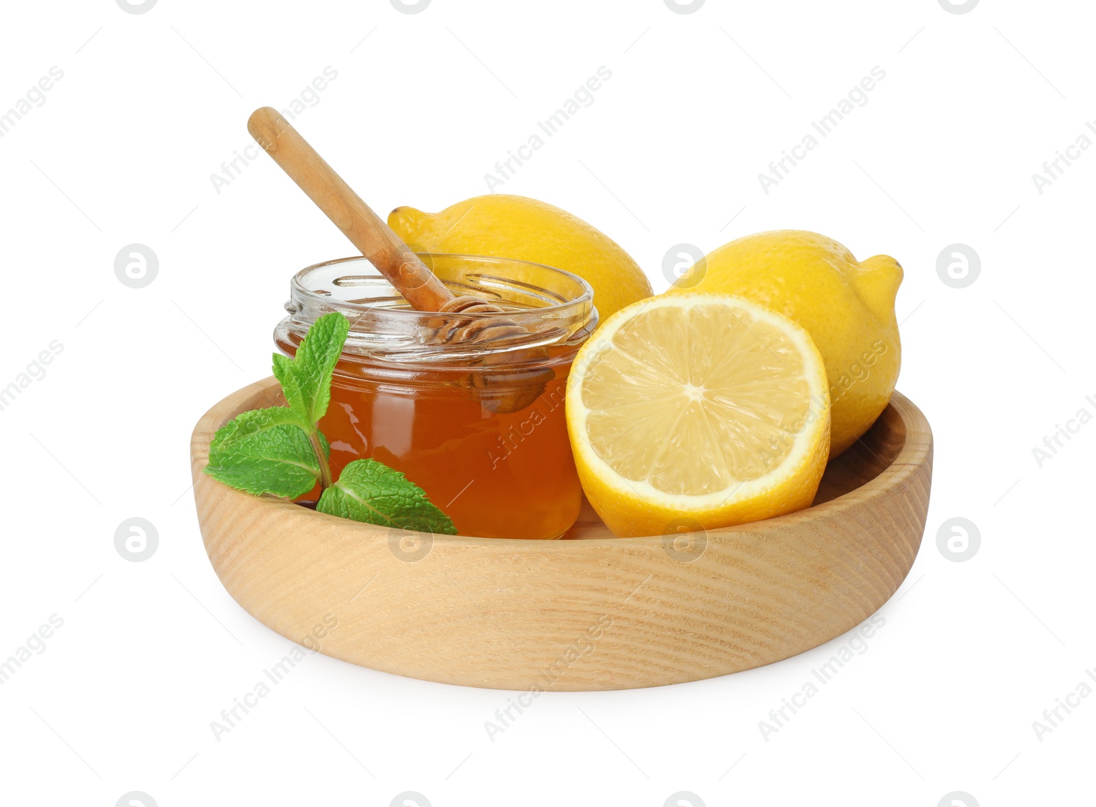 Photo of Ripe lemons, mint, jar of honey and dipper isolated on white