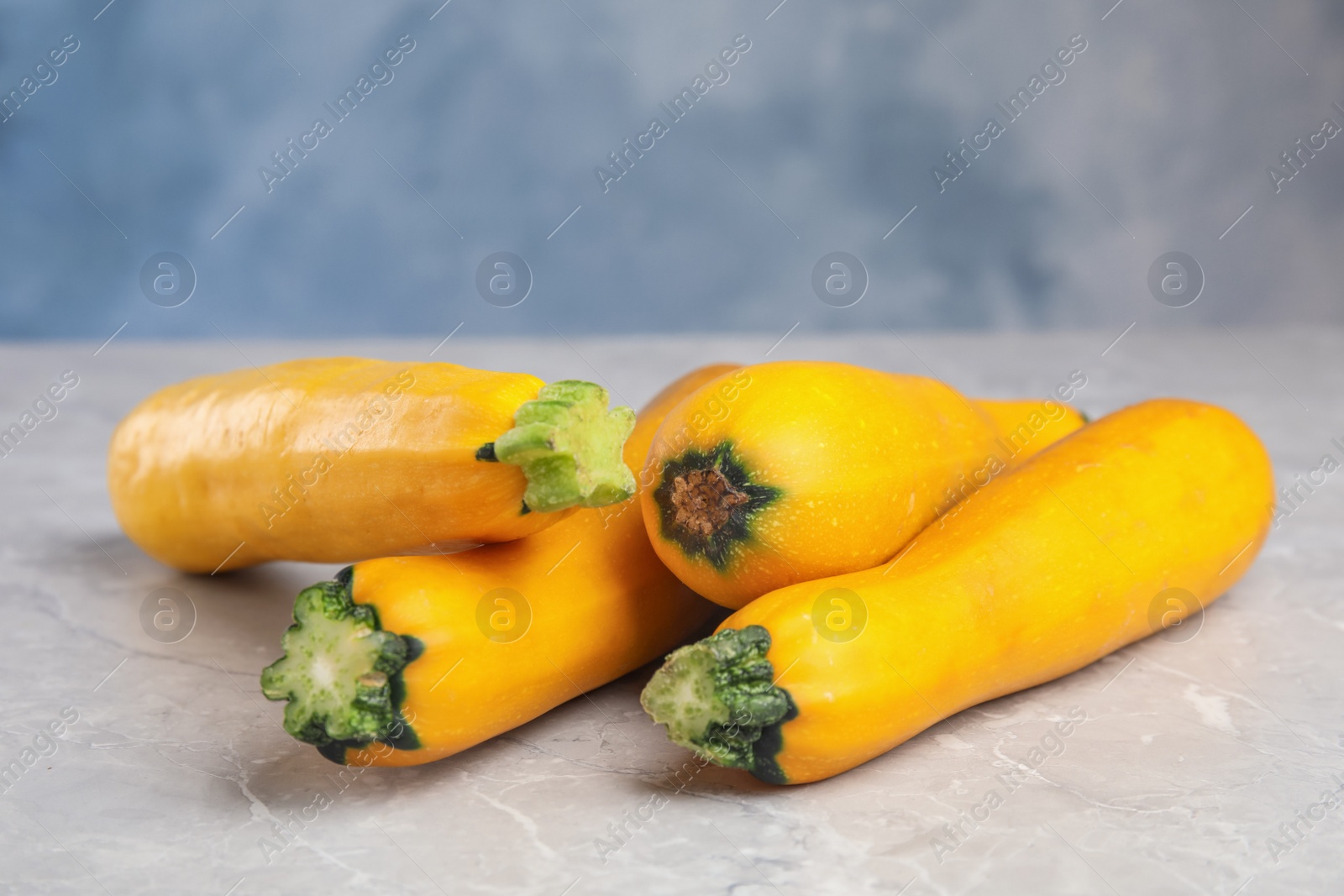 Photo of Fresh ripe yellow zucchini on grey table