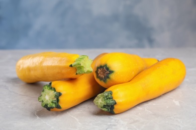 Fresh ripe yellow zucchini on grey table