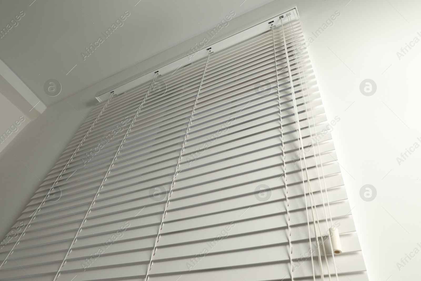 Photo of Window with closed blinds in room, low angle view