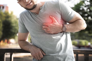 Image of Man having heart attack outdoors, closeup view