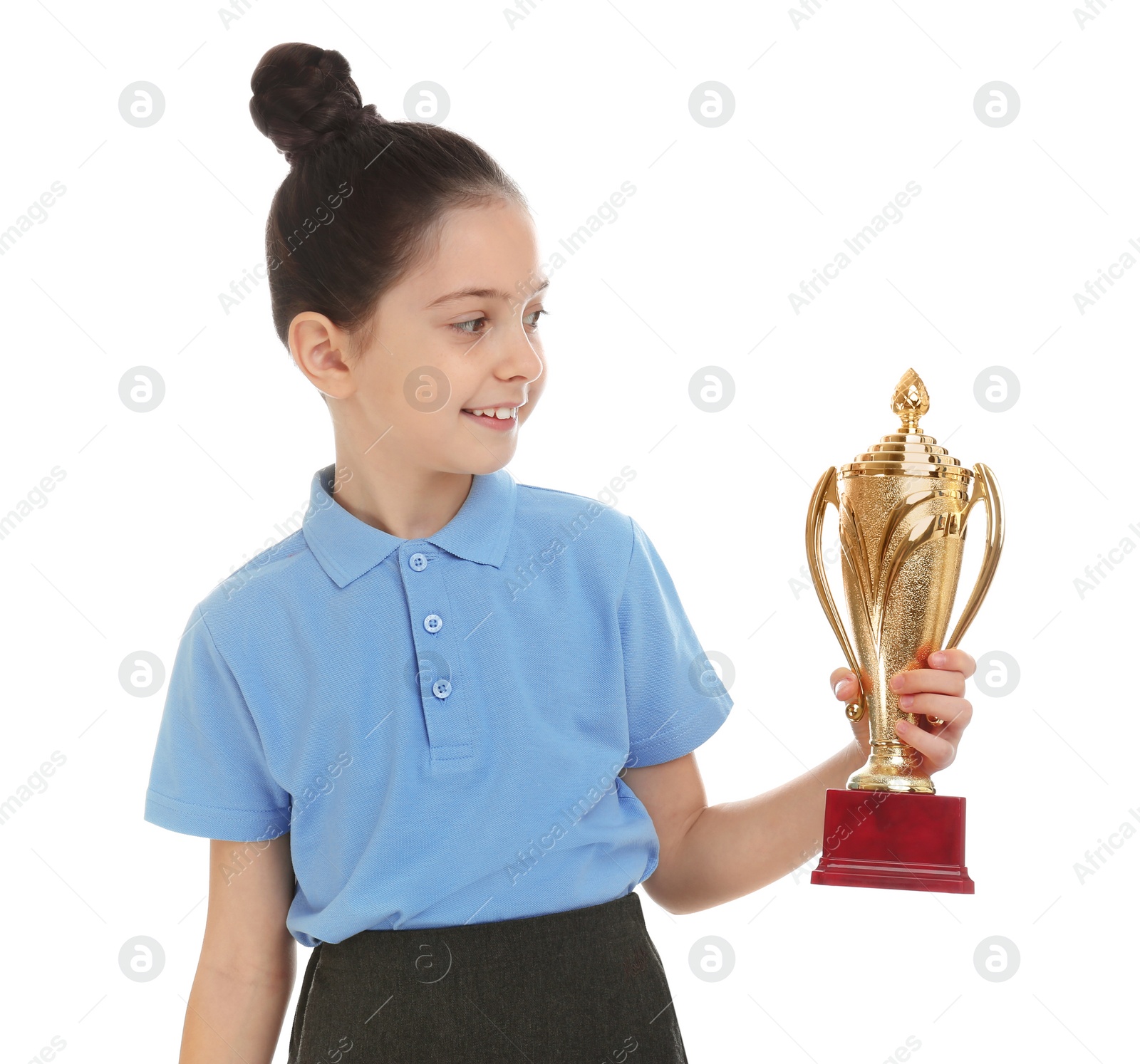 Photo of Happy girl in school uniform with golden winning cup isolated on white