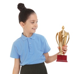 Happy girl in school uniform with golden winning cup isolated on white