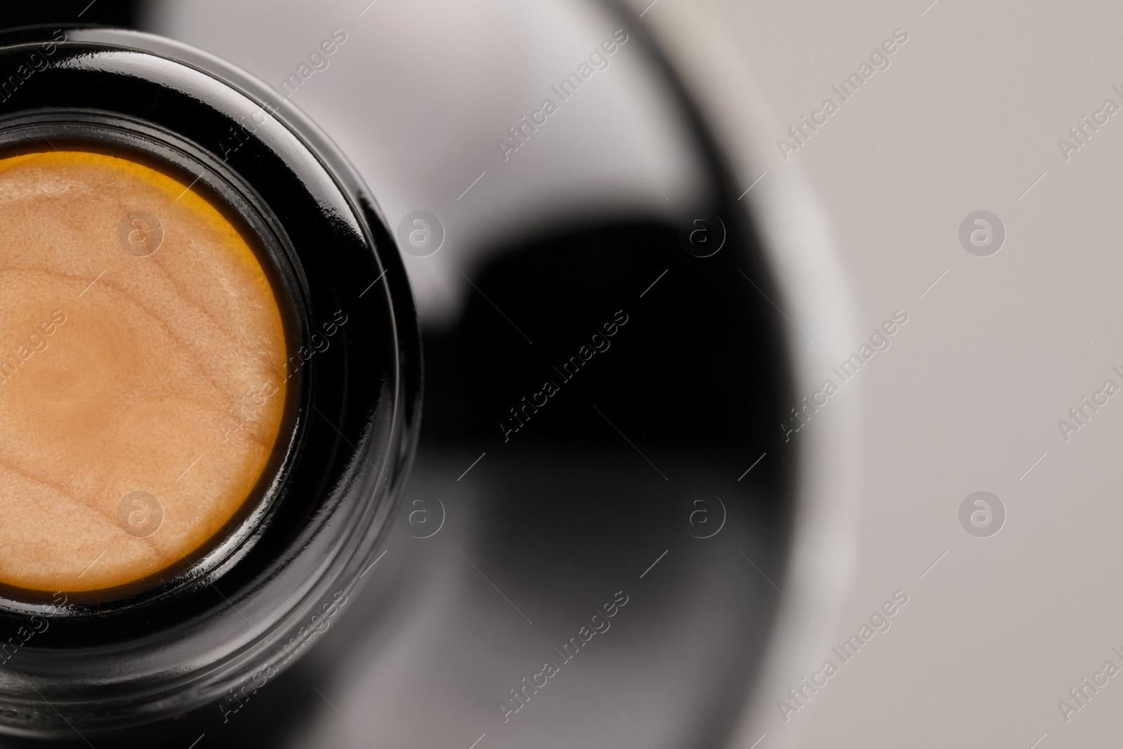 Photo of Closeup view of cork in wine bottle on grey background, space for text
