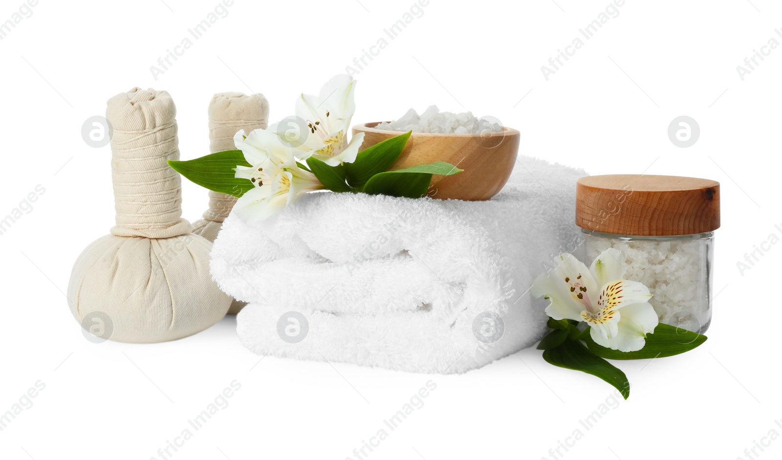 Photo of Spa composition. Towel, herbal massage bags, sea salt and beautiful flowers on white background