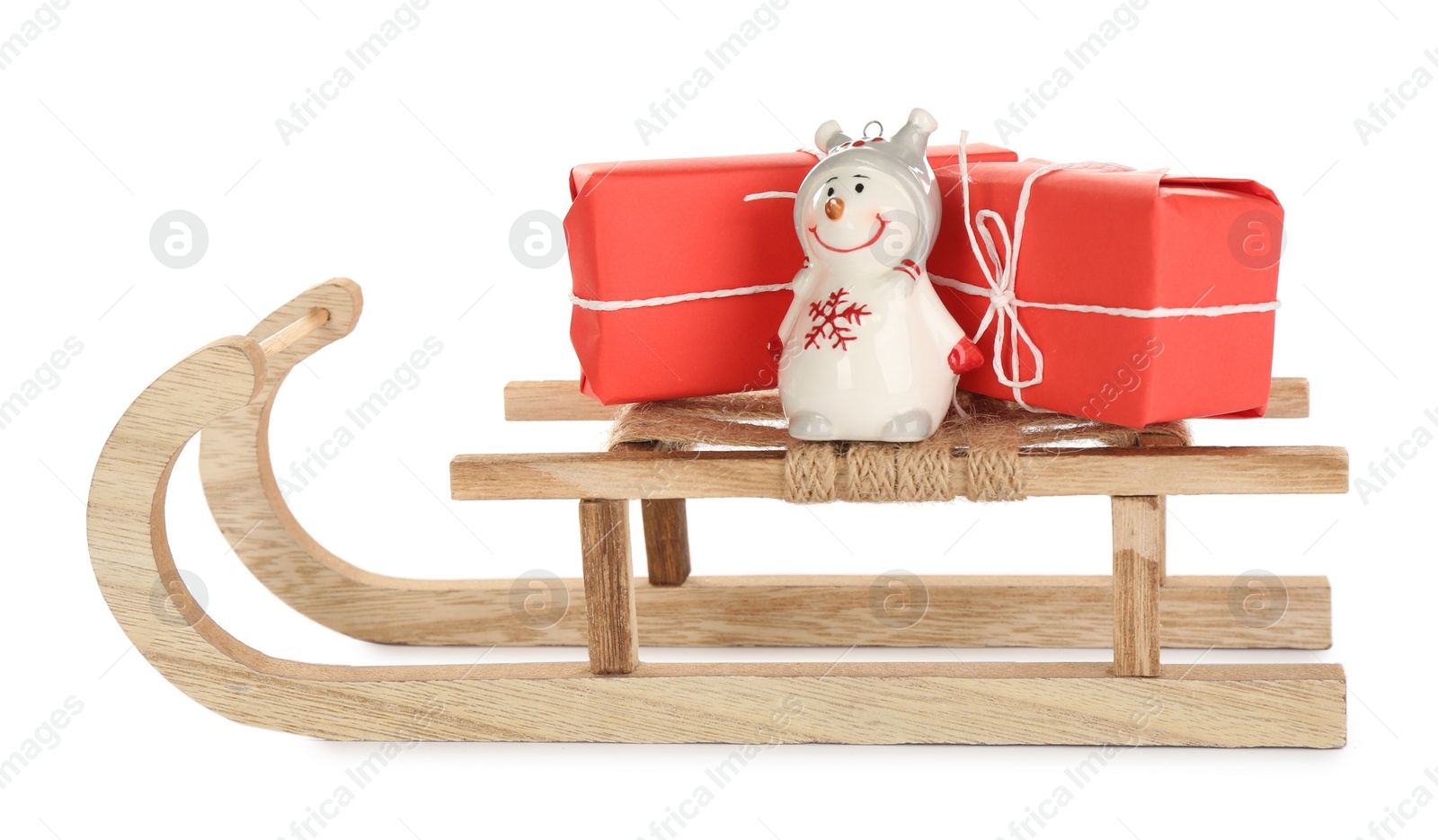 Photo of Wooden sleigh with presents and decorative snowman on white background