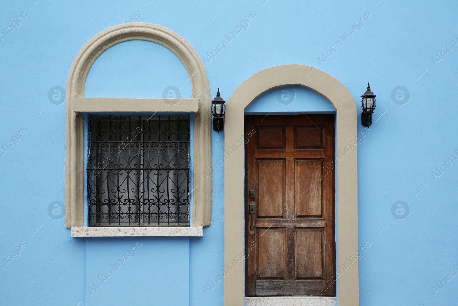 Photo of Entrance of residential house with wooden door and window