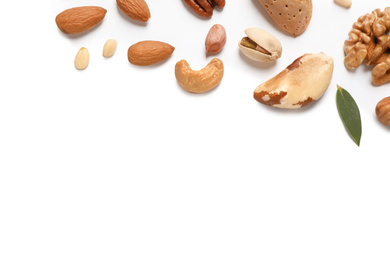 Different delicious nuts on white background, flat lay. Space for text