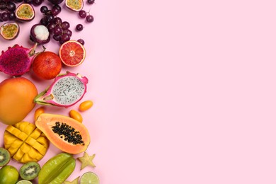 Photo of Many different delicious exotic fruits on pink background, flat lay. Space for text