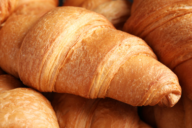 Photo of Tasty fresh croissants as background, closeup view