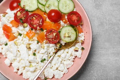 Photo of Delicious cottage cheese with vegetables served for breakfast on light grey table, top view