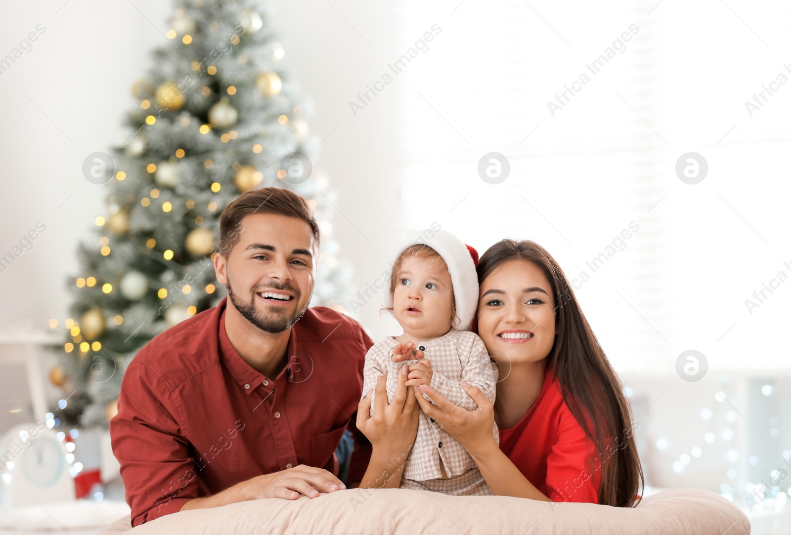 Photo of Happy family with cute baby at home. Christmas celebration