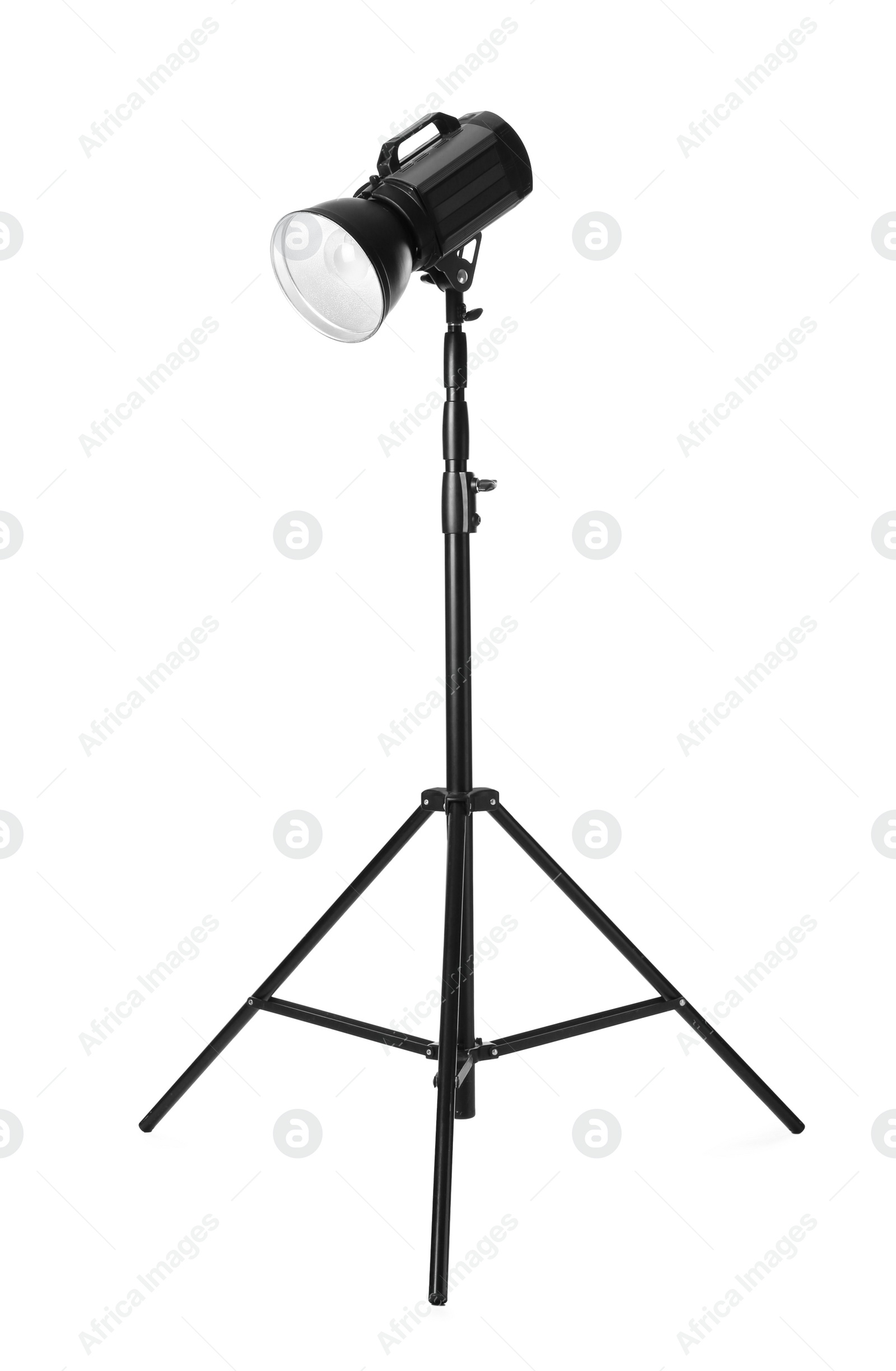 Photo of Studio flash light on tripod against white background. Professional photographer's equipment