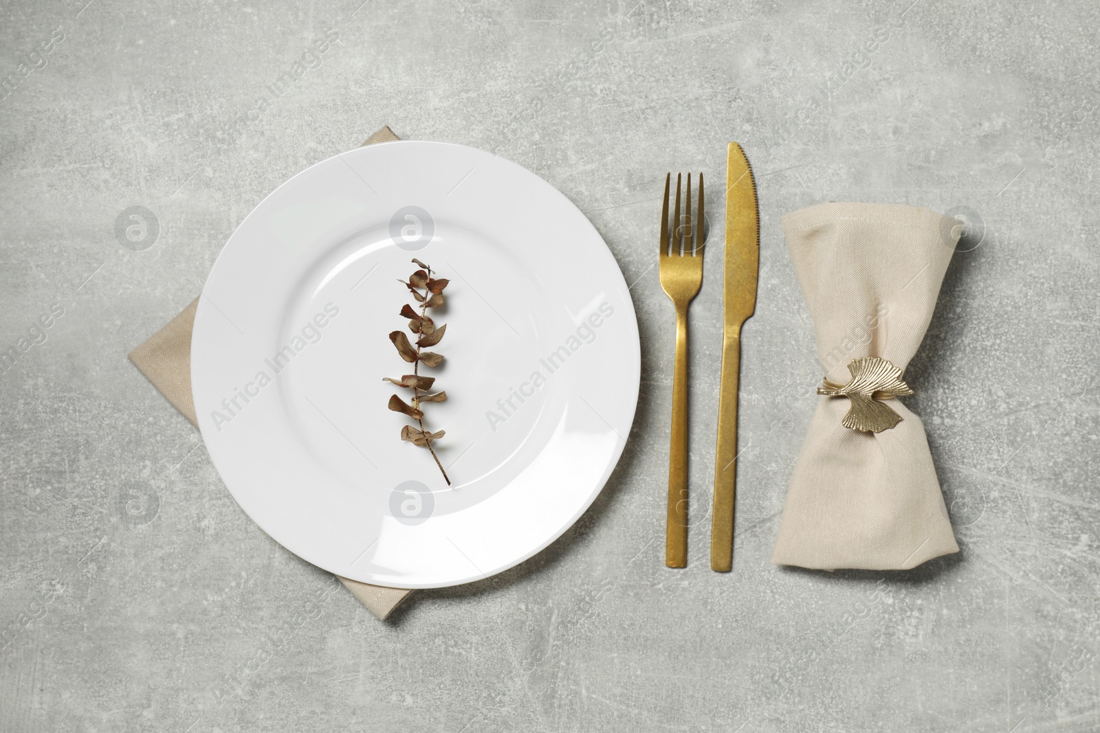 Photo of Stylish setting with elegant cutlery on grey table, flat lay