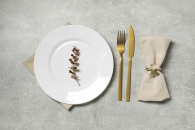 Stylish setting with elegant cutlery on grey table, flat lay