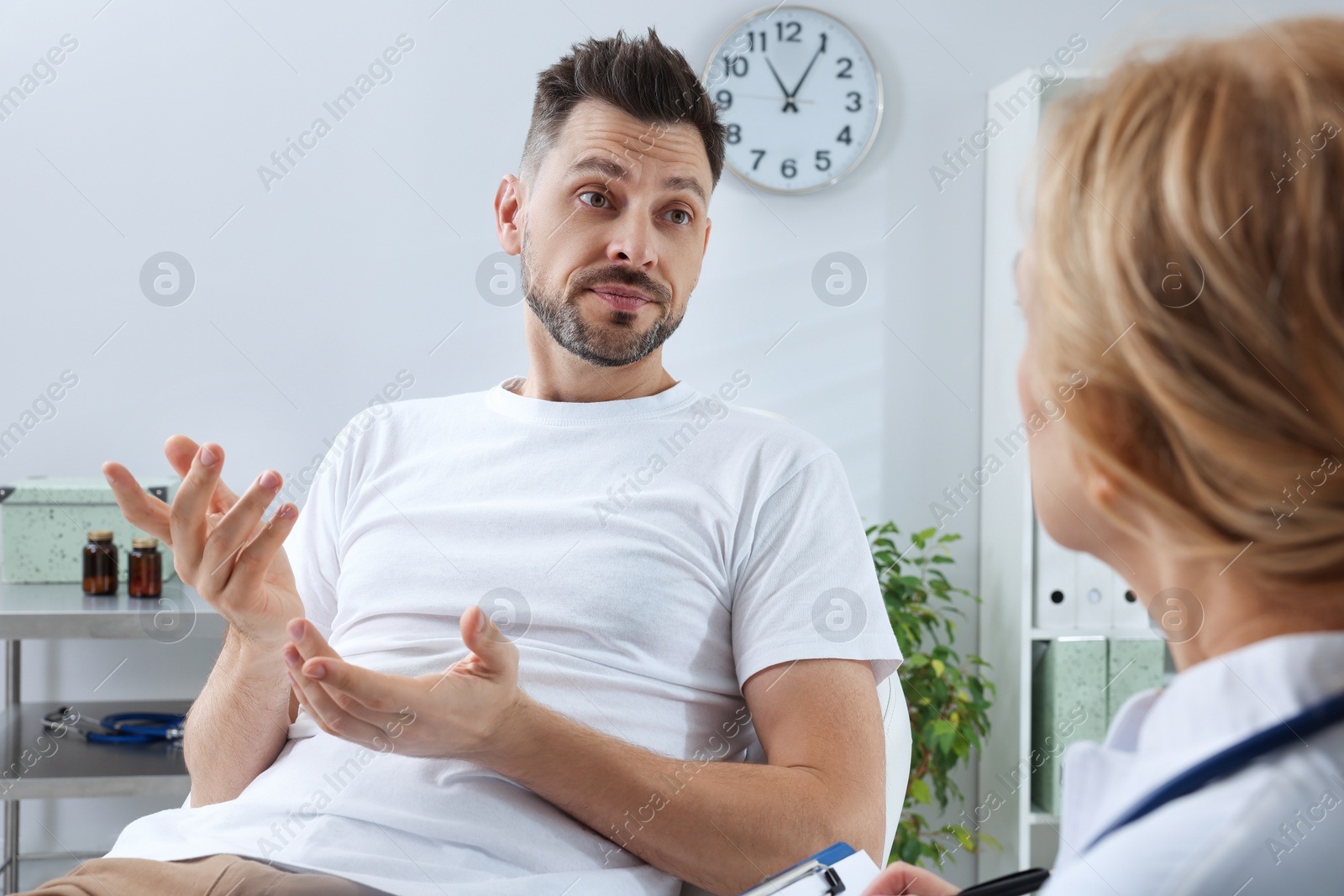 Photo of Doctor listening to patient's complaints during consultation in clinic