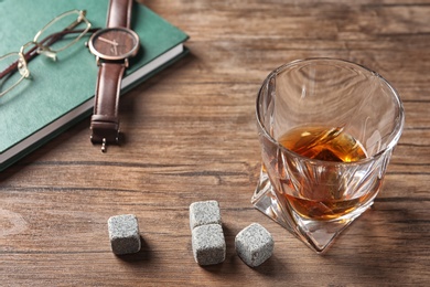 Photo of Glass with liquor and whiskey stones on table