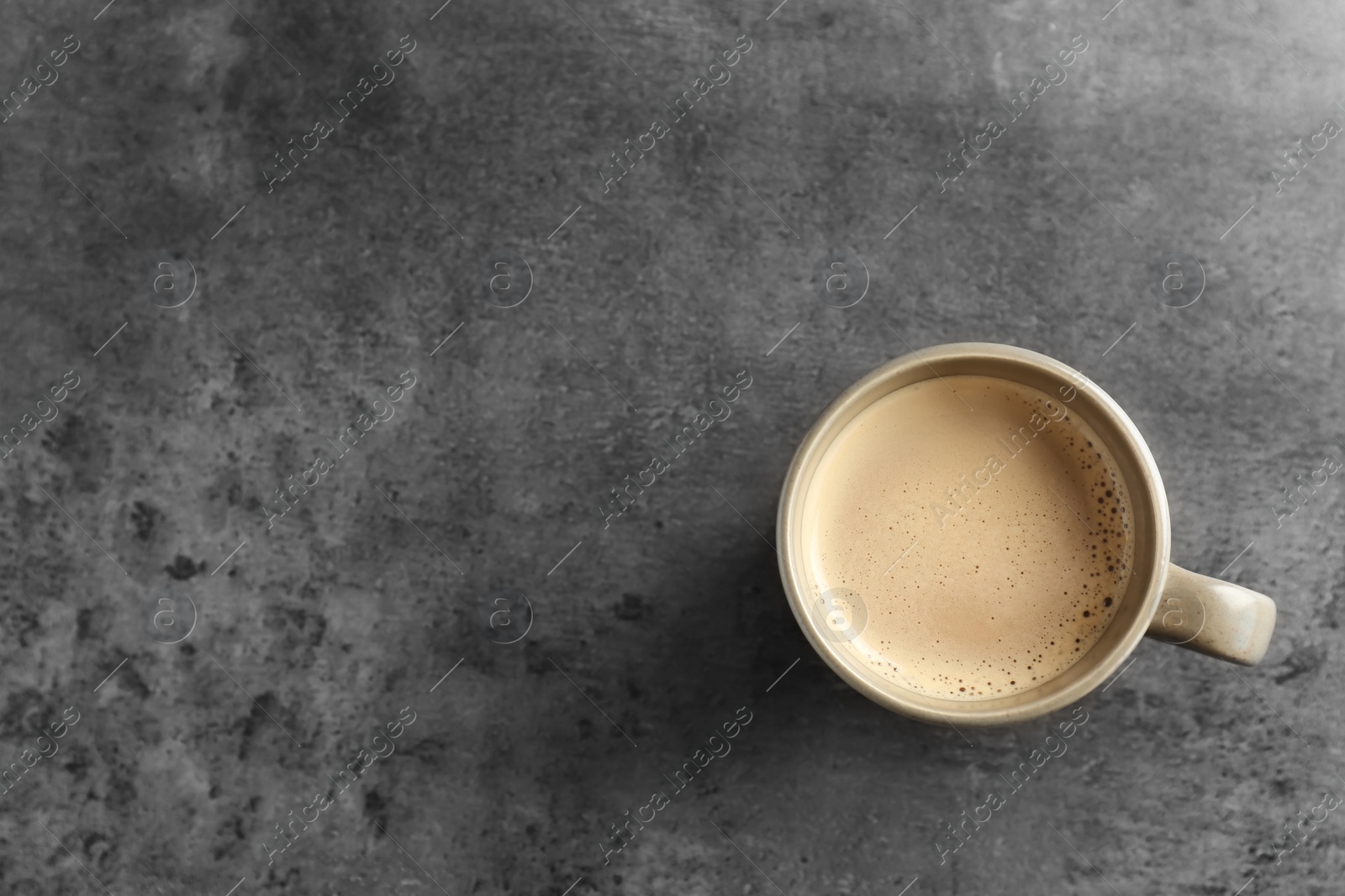 Photo of Cup of aromatic hot coffee on grey background, top view