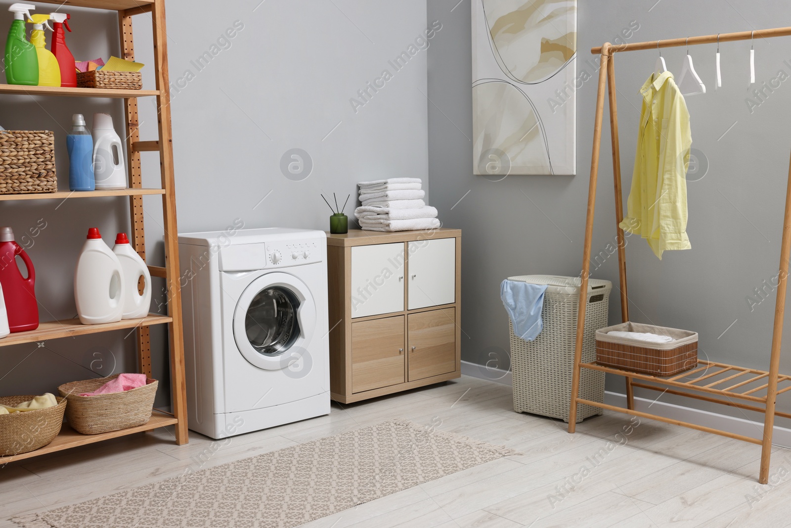 Photo of Laundry room interior with washing machine and furniture