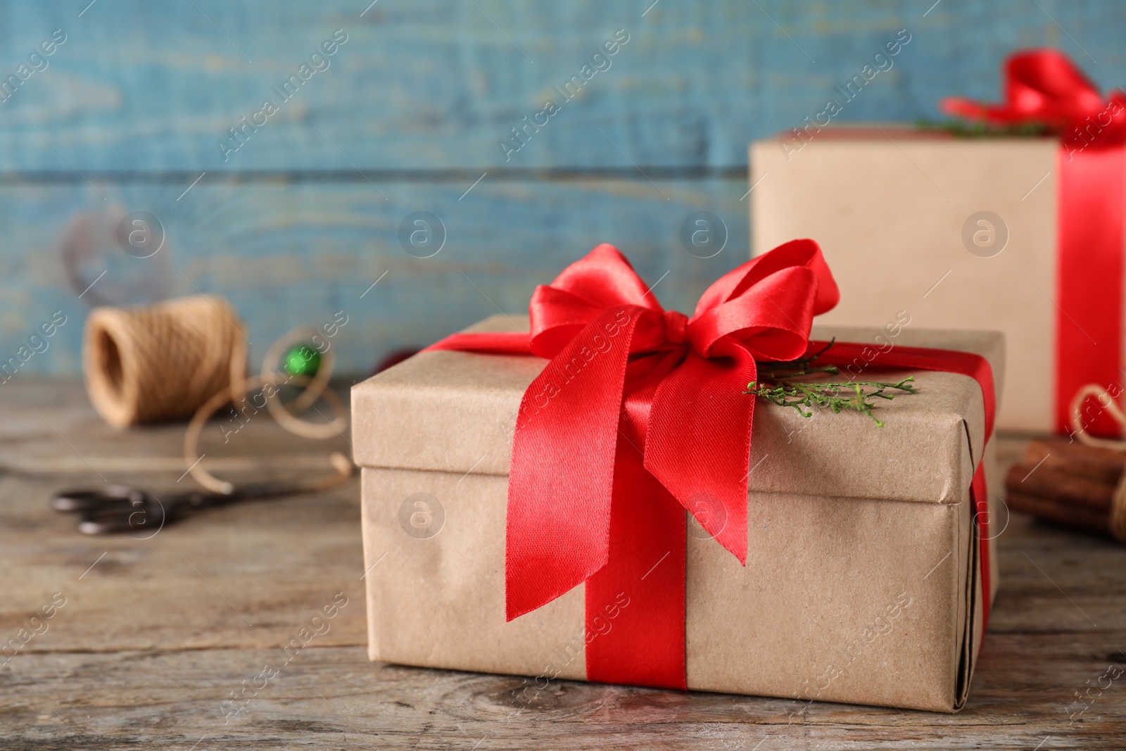 Photo of Christmas gifts on table against blue wooden background