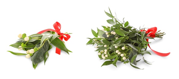 Mistletoe bunches with red bows on white background. Traditional Christmas decor