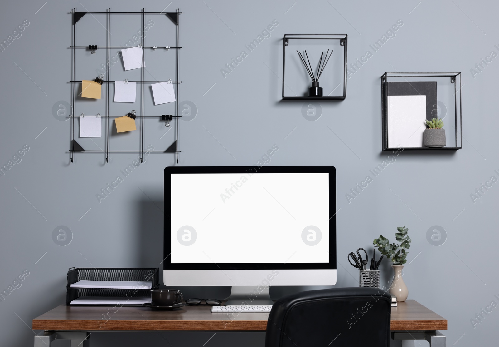 Photo of Cozy workspace with modern computer on wooden desk