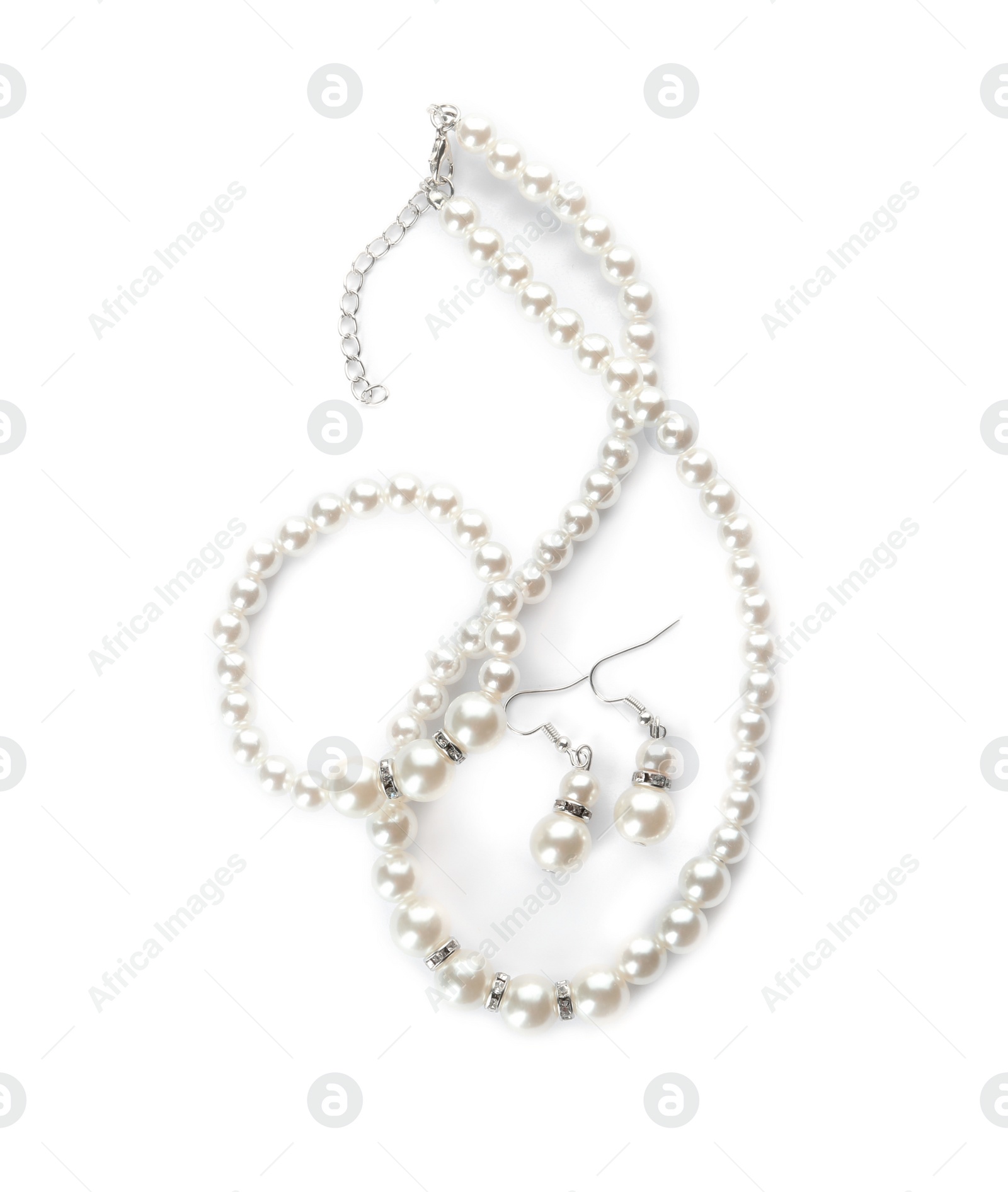 Photo of Elegant pearl necklace, bracelet and earrings on white background, top view