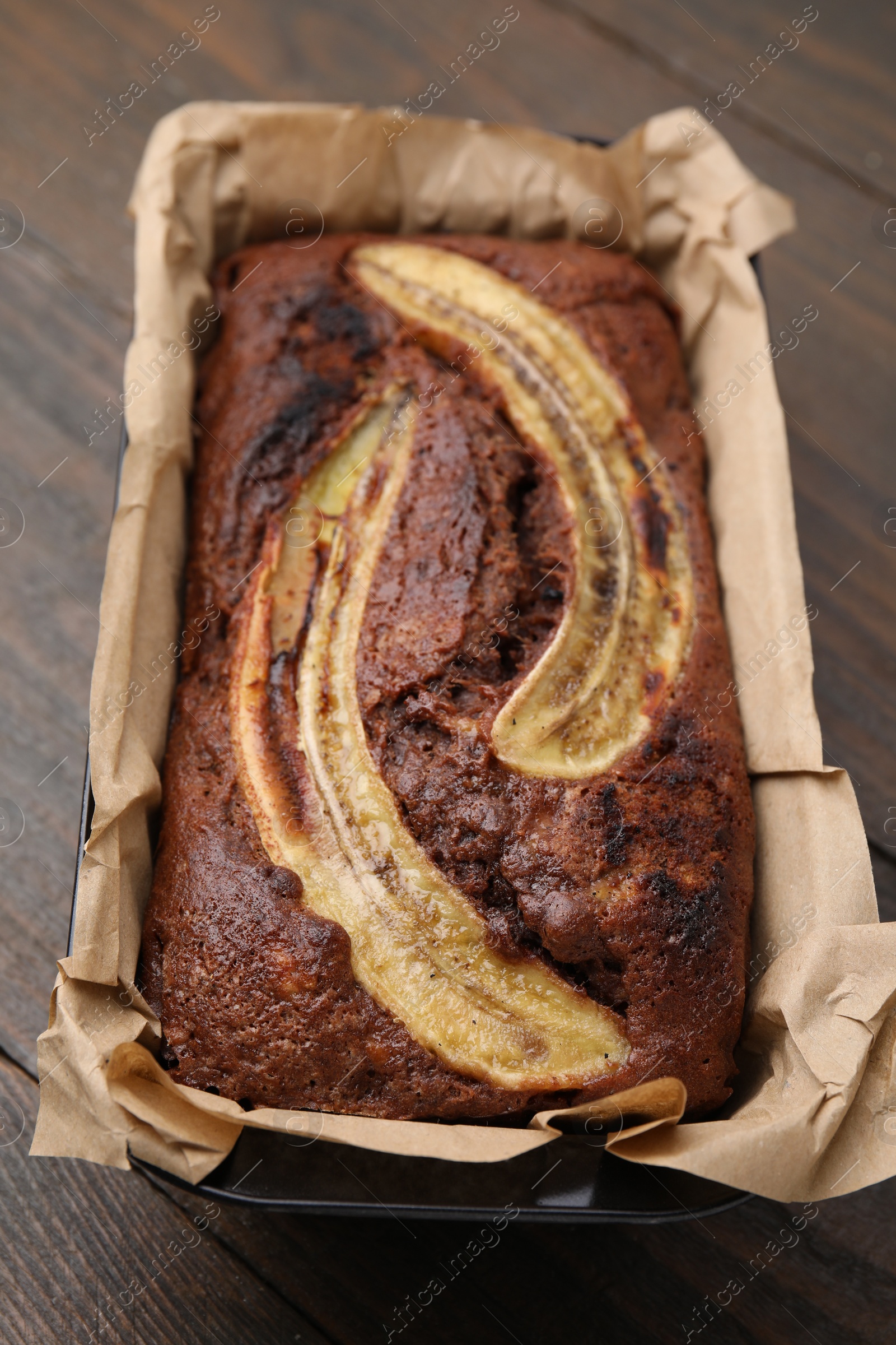 Photo of Delicious banana bread on wooden table, closeup