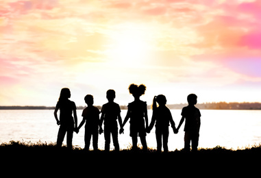 School holidays. Group of children standing together near river 