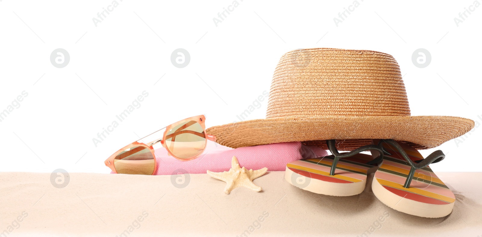 Photo of Different stylish beach accessories on sand against white background, space for text