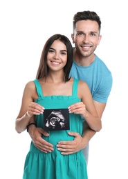 Photo of Happy young family with ultrasound picture on white background