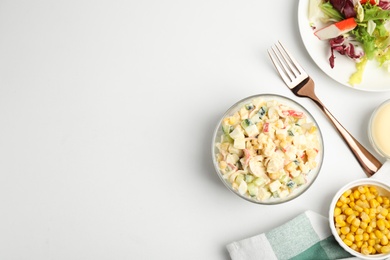 Photo of Delicious salad with fresh crab sticks and corn served on white table, flat lay. Space for text