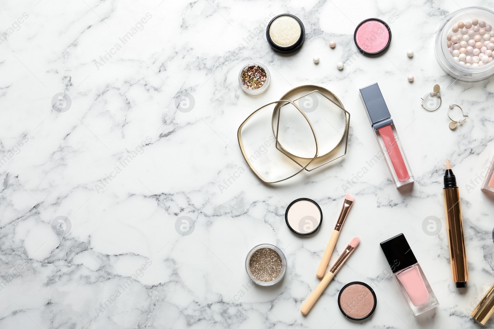 Photo of Beautiful composition with lipsticks and bijouterie on marble background, flat lay. Space for text