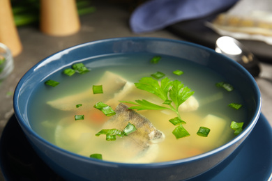 Photo of Delicious fish soup in bowl on table, closeup view