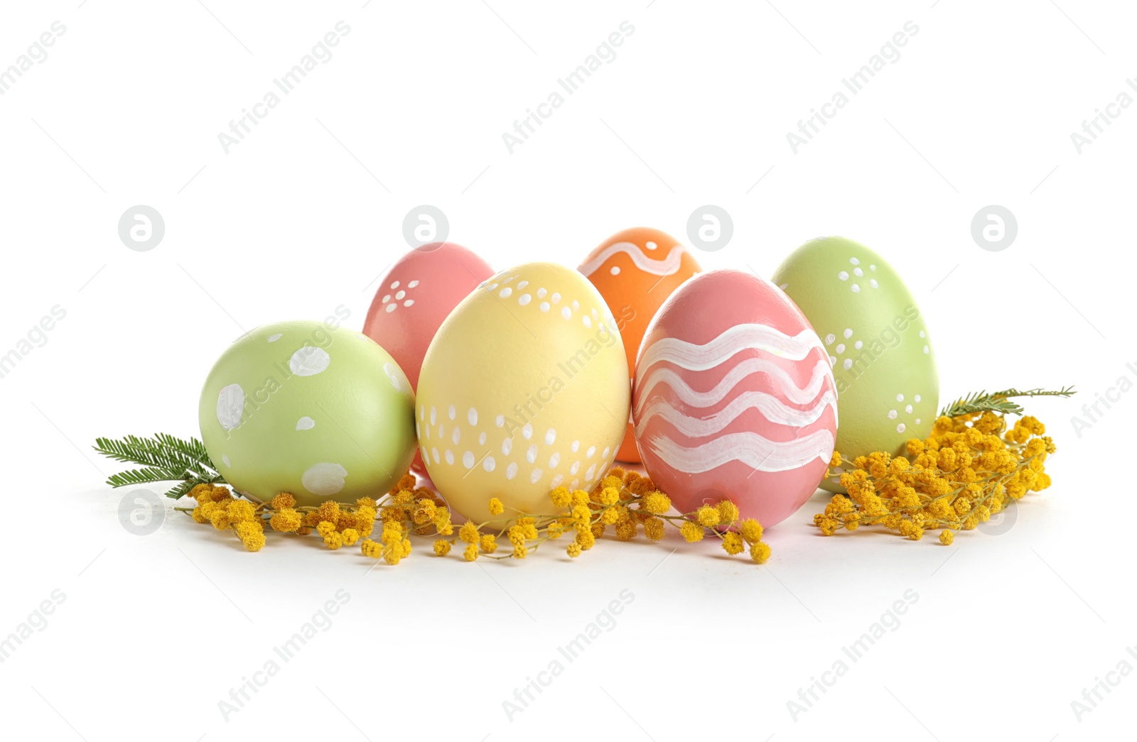 Photo of Colorful painted Easter eggs and flowers on white background