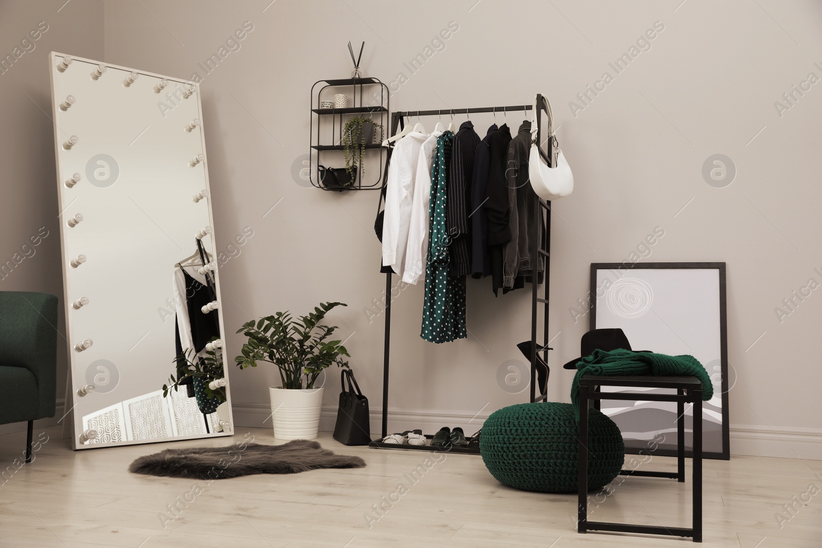 Photo of Modern dressing room interior with clothing rack and mirror