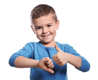 Photo of Little boy showing THUMB UP and DOWN gesture in sign language on white background