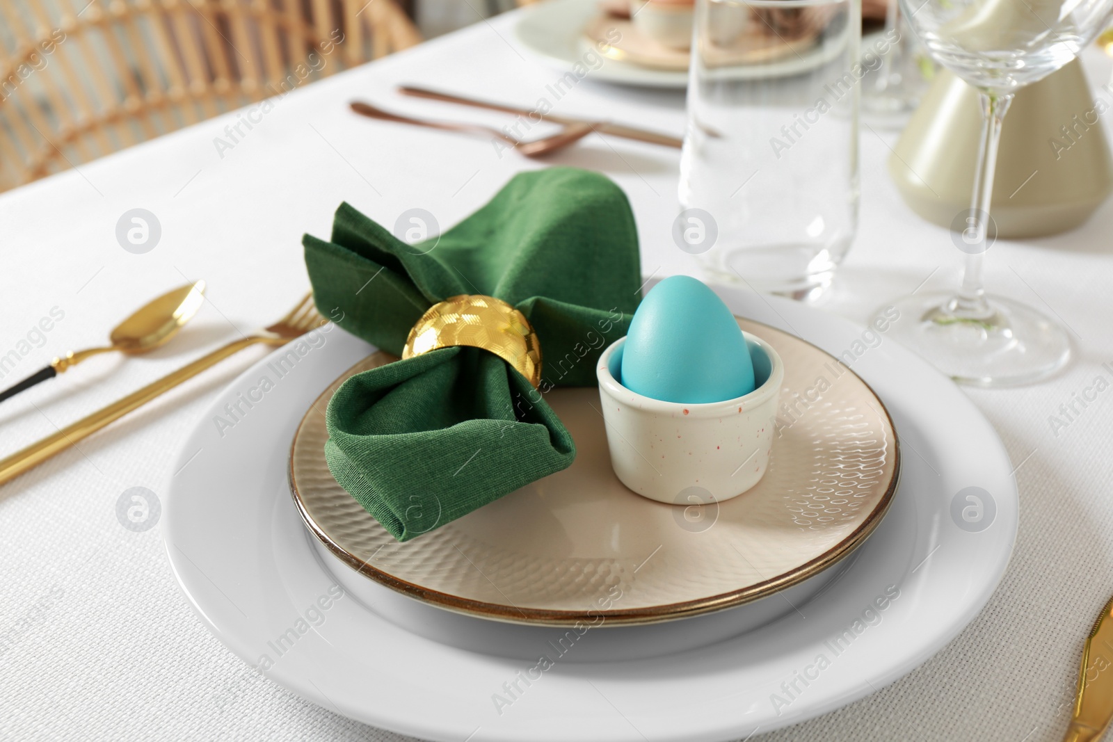 Photo of Festive Easter table setting with painted egg