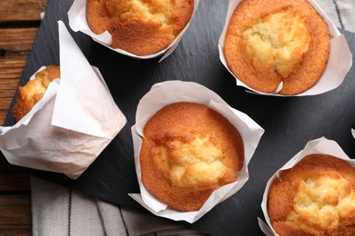 Photo of Delicious sweet muffins on wooden table, top view