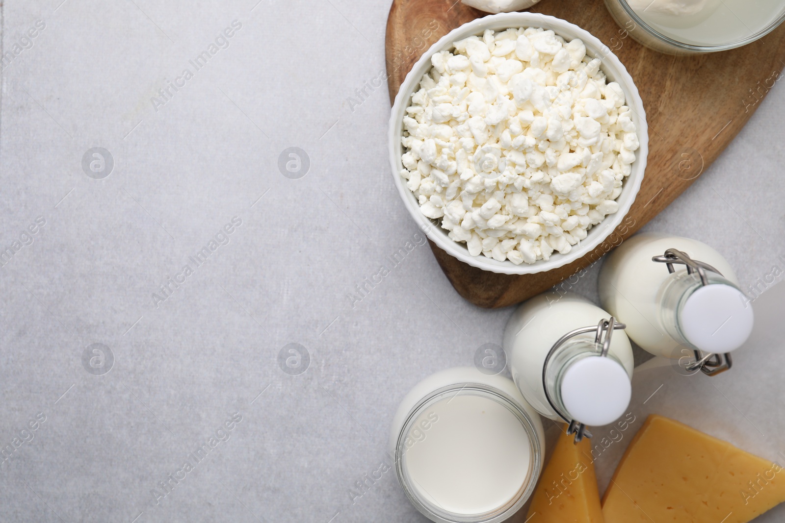 Photo of Different fresh dairy products on light table, flat lay. Space for text