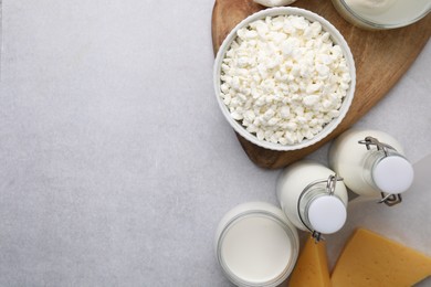 Different fresh dairy products on light table, flat lay. Space for text