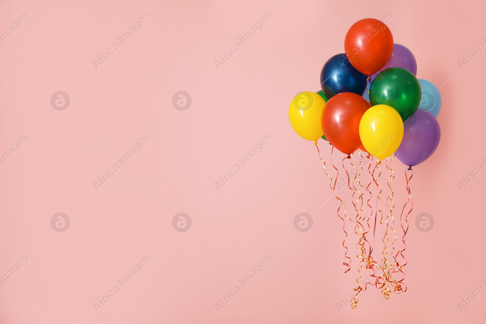 Photo of Bright balloons on color background, space for text. Celebration time