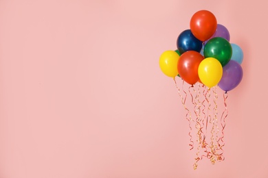 Photo of Bright balloons on color background, space for text. Celebration time