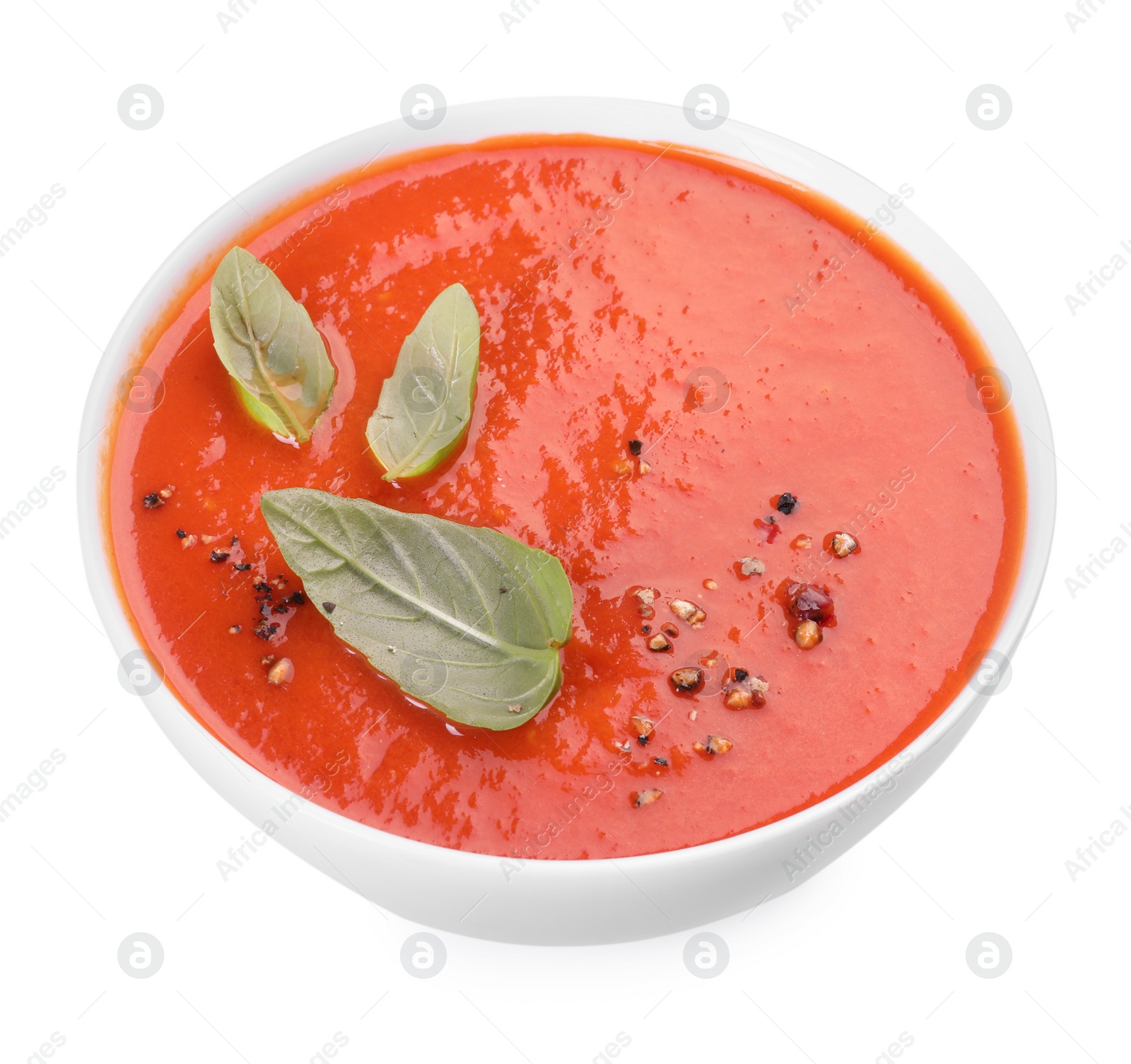 Photo of Delicious tomato soup with basil and spices isolated on white