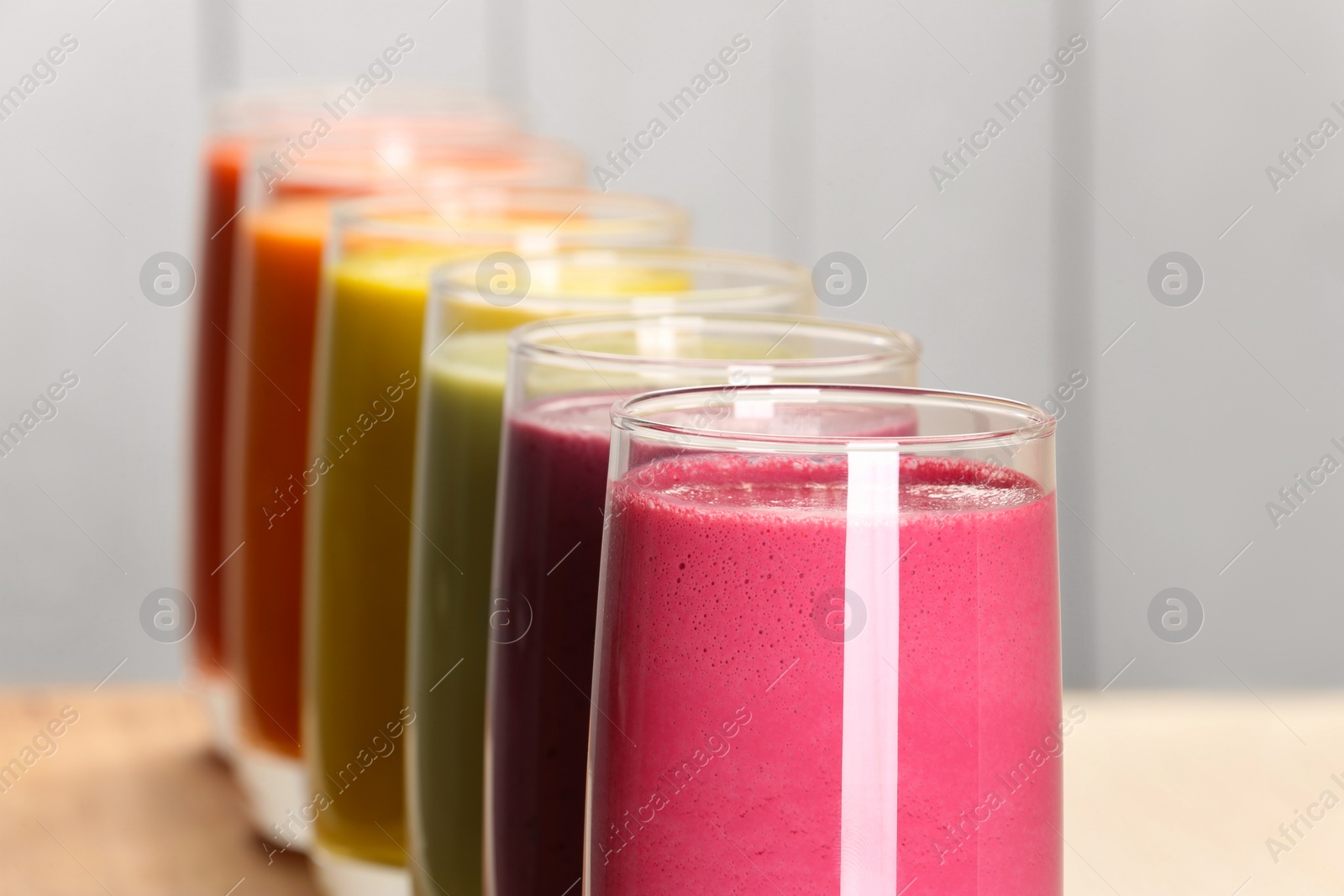 Photo of Many different tasty smoothies against white background, closeup