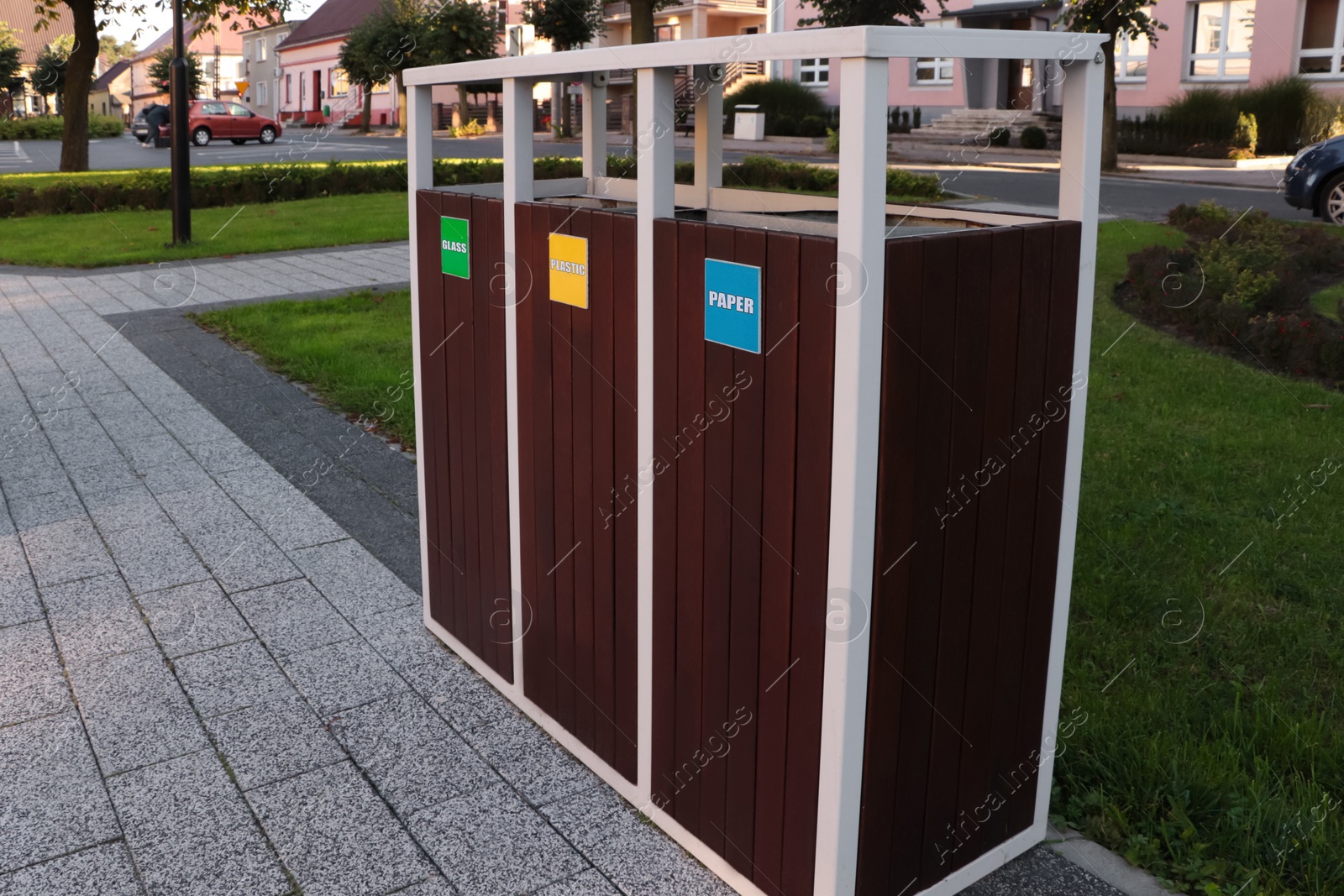 Photo of Different sorting bins for waste recycling outdoors