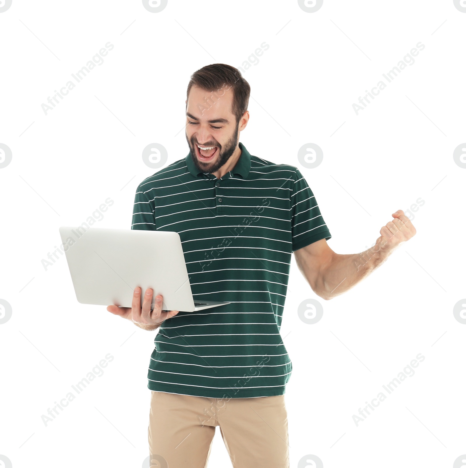 Photo of Emotional young man with laptop celebrating victory on white background